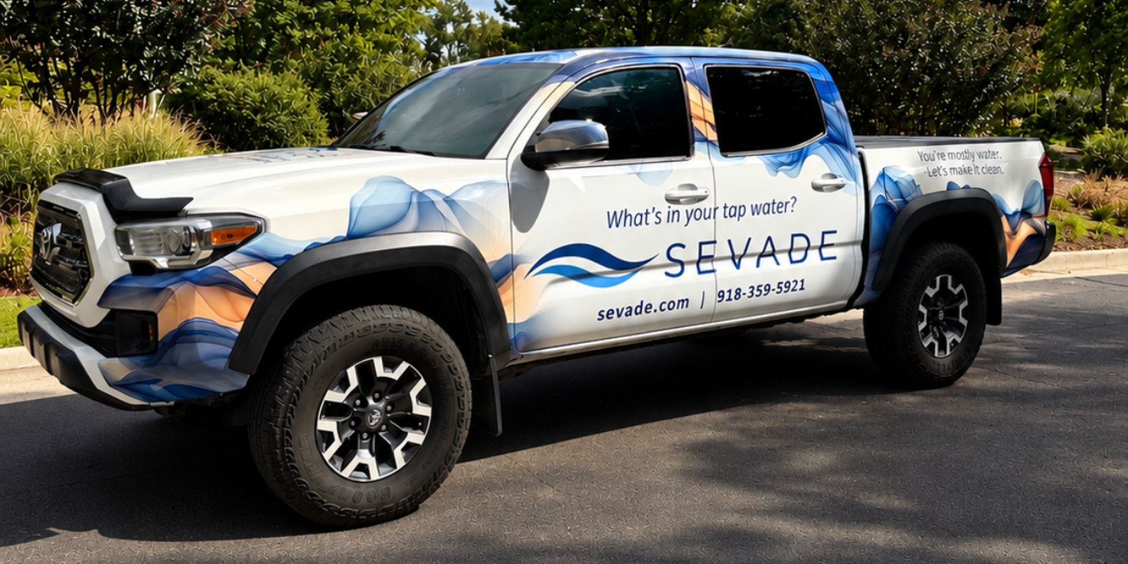 The Sevade truck &mdash; a wrapped Toyota Tacoma reading &ldquo;What&rsquo;s in your tap water?&rdquo; with sevade.com and 918-359-5921 along the side
